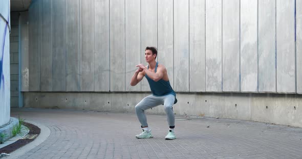 Young Athletic Man Doing Squats Exercises Sports Training Alone