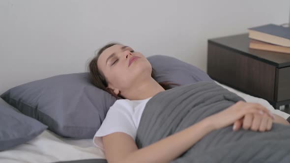 Relaxed Woman Sleeping in Bed Peacefully