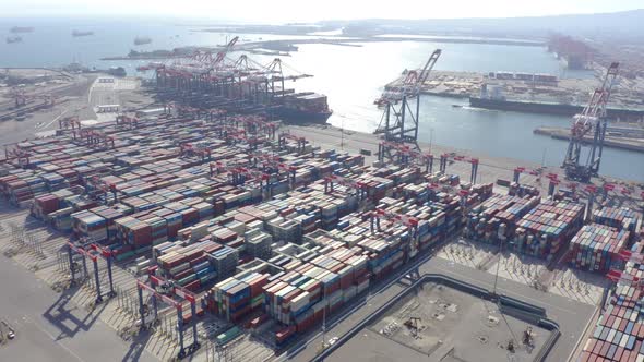 Cargo containers in busy port, aerial. Drone shot. 