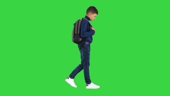 Cheerful Boy in Polo Neck Walking with a Backpack on a Green Screen Chroma Key