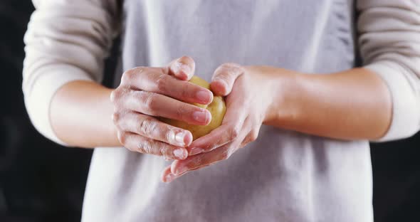 Woman molding a dough ball 4k