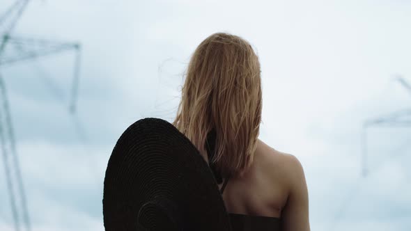 Flamboyant Girl In Black Dress Goes By The Field.