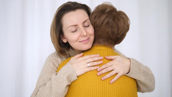 Portrait Of Granddaughter Hugging Grandmother With Love, Gratefulness And Care