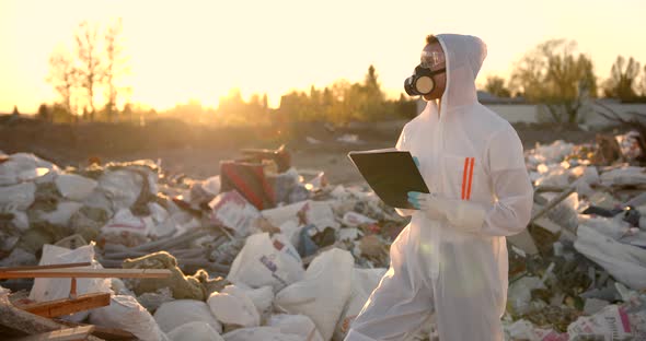 Researcher at Plastic Landfill Analyzing Environmental Pollution Level