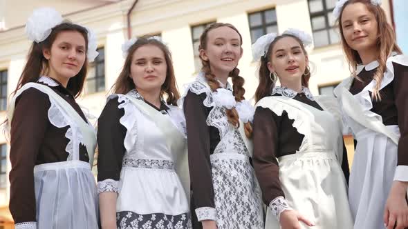 Happy Russian Female Graduates Pose on Their Graduation Day