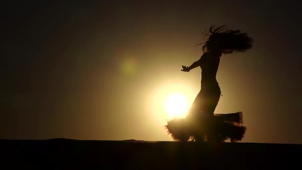 Girl Dancer Dances Gracefully Against the Background of a Hot Sunset, Silhouette, Slow Motion