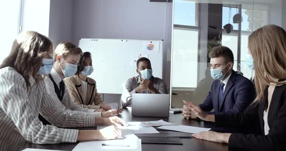 Team of Business Partners, Workers Sits in Office at Conference Meeting Together, Wears Protective