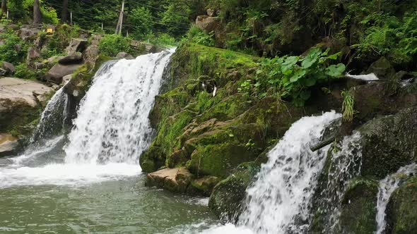 Mountain River Waterfall Flowing Between Rocky Shores in Carpathians Mountains Ukraine