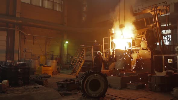 Hard Work in a Foundry. Metal Smelting Furnace in Steel Mill. Molten Metal Pouring, Metallurgy