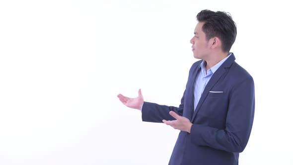 Stressed Young Asian Businessman Showing To the Back