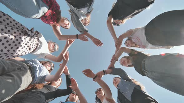 A Group of Girls Makes a Circle Shape Holding Each Other's Hands