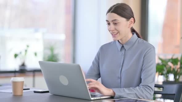 Young Latin Woman Talking on Video Call on Laptop