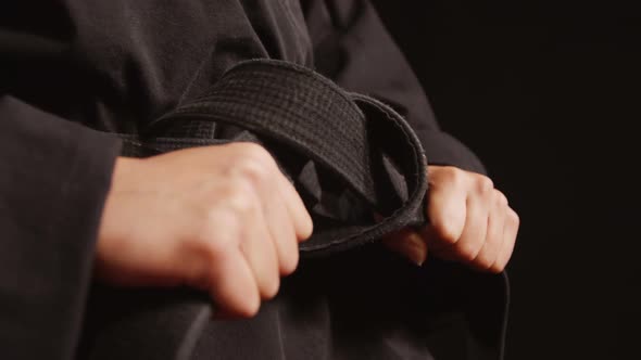 Karate player tying his belt