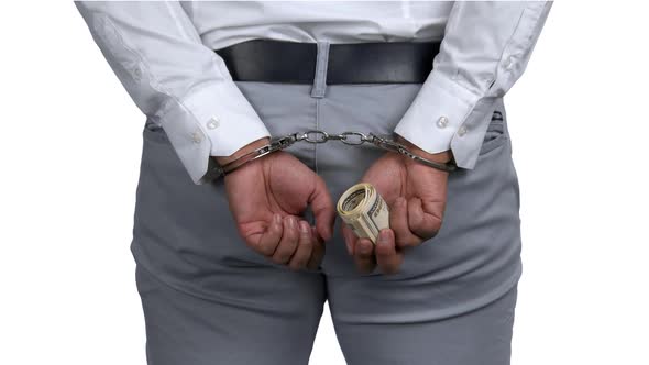 Close Up Male Hands in Handcuffs Holding Money