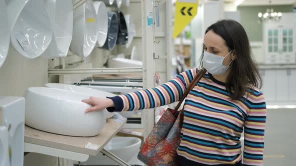 Female Choosing a New Sink for Bathroom in Store