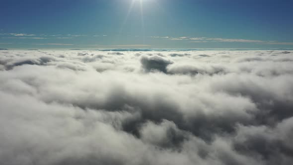 Above the clouds. Sunrise foggy morning.