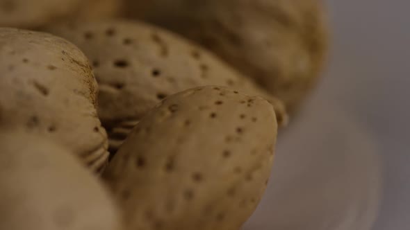 Cinematic, rotating shot of almonds on a white surface - ALMONDS 