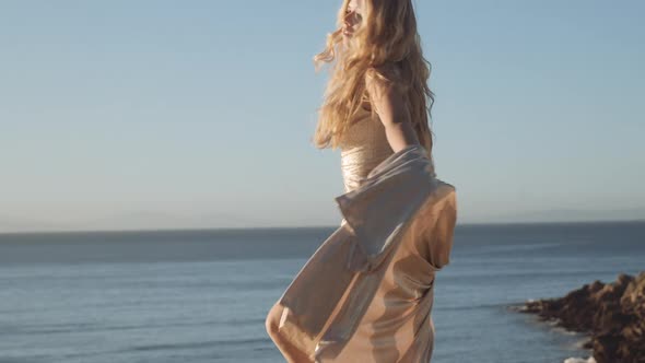 Dancing Woman In Dress On Sunny Beach