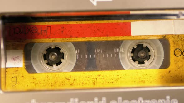 Vintage Yellow Audio Cassette in the Tape Recorder Playing and Rotates