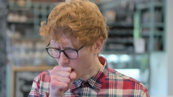 Close Up of Sick Young Redhead Man Coughing