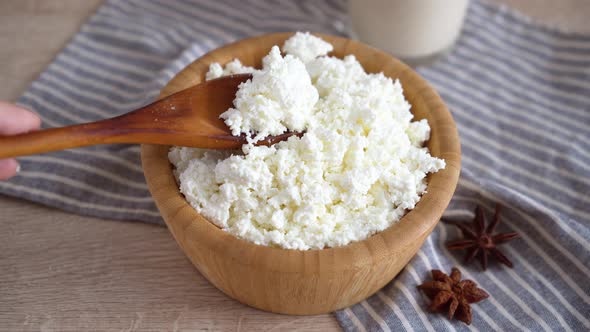 Traditional homemade cottage cheese in a wooden bowl Healthy and fermented food
