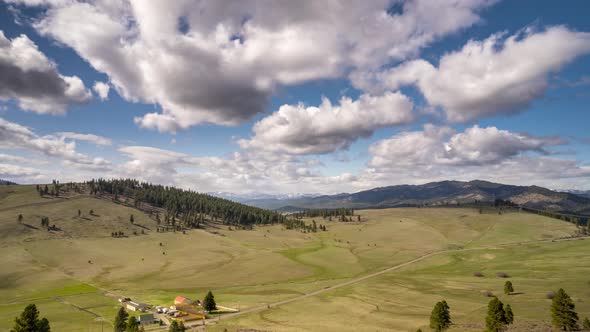 Roling clouds splash dark shadows across a green fertile hill country, Eastern Washington
