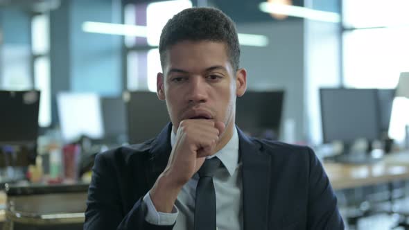 Portrait of Sick African Businessman Coughing in Office