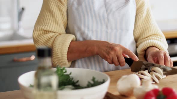 Hands of Woman Chopping Champignon on Kitchen