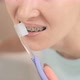 Young Woman with Braces on Her Teeth Brushing Her Teeth with a Toothbrush Closeup Before Mirror - VideoHive Item for Sale