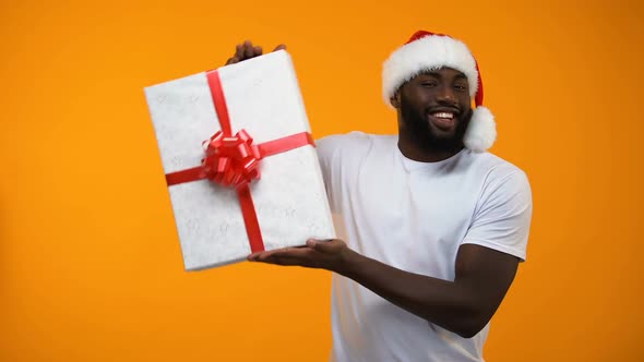 Santa Man Holding Gift Box and Winking, Holidays Discounts, Time to Buy Presents