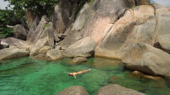 Exotic Shot of Woman Laid on Water Surface at Tropical Lagoon