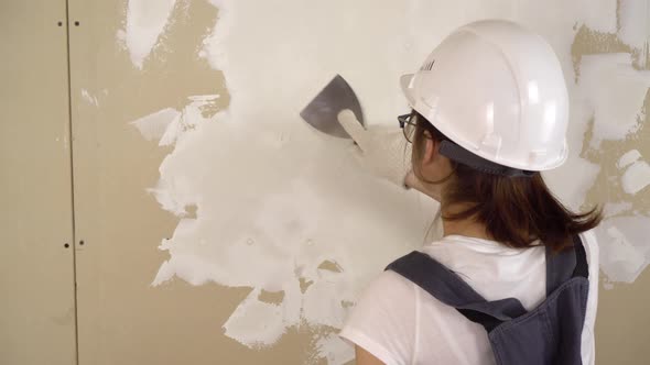 The Builder Plasters the Wall in the Room