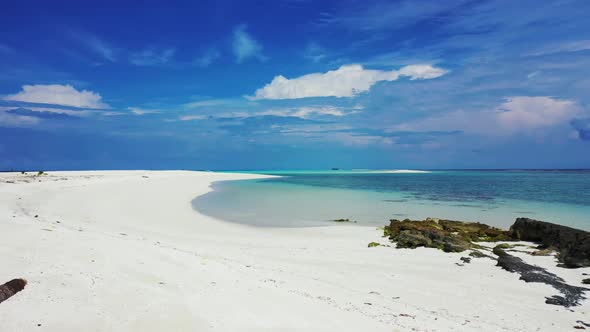 Aerial flying over panorama of exotic coastline beach voyage by clear ocean and bright sandy backgro