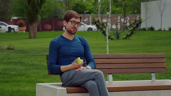 Handsome Man Eating Heathy food. Apple as Healthy Snack.