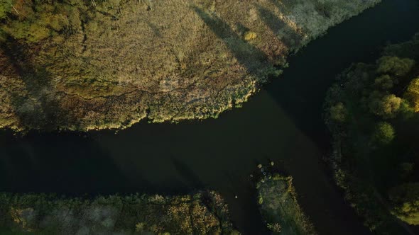 Park area. A winding river. Trees with yellow autumn leaves are visible. Aerial photography.