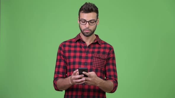 Young Happy Handsome Bearded Hipster Man Using Phone