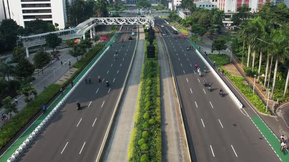 Aerial view of Bicyclist group riding on bike ride at highway, motorcycle and car.