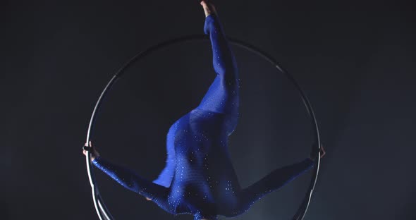 Headstand in a Spinning Hoop By a Young Pretty Woman in Blue Costume Gymnastics