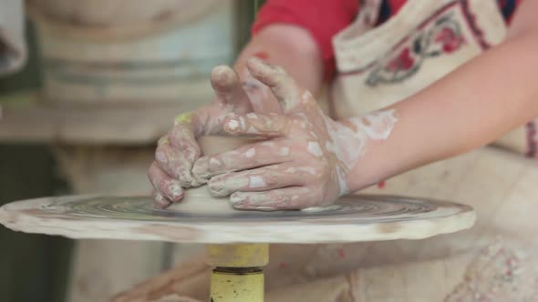 Hands of Girl Working on Potters Wheel.