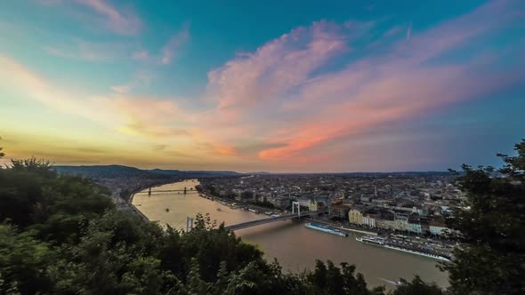 Aerial View of Budapest and Danube River With Ships Under Glowing Sky at Dusk