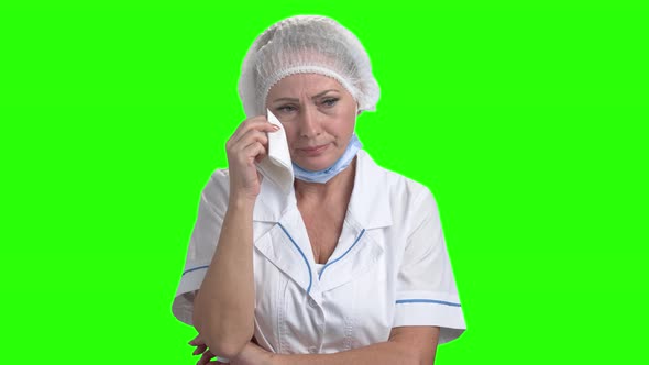 Portrait of Crying Doctor on Green Screen.