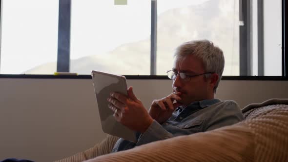 Caucasian man using computer tablet in creative office