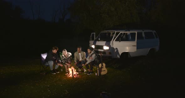 Multiracial Friends Having a Picnic By Fire