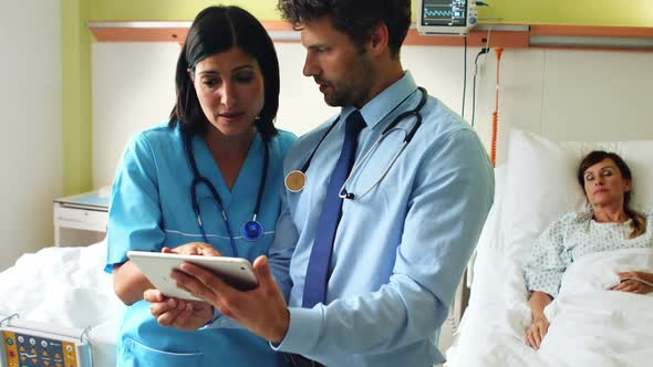 Doctors discussing on digital tablet