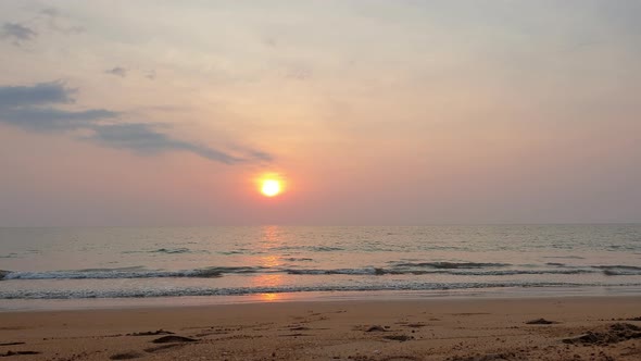 Golden orange sunset over horizon in sandy beach of Thailand