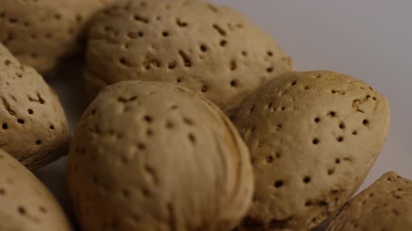 Cinematic, rotating shot of almonds on a white surface 