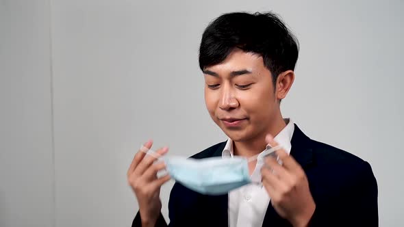 Asian young man wearing protective mask in slow motion, Protection versus viruses and infection