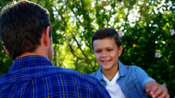 Father and son embracing each other in park