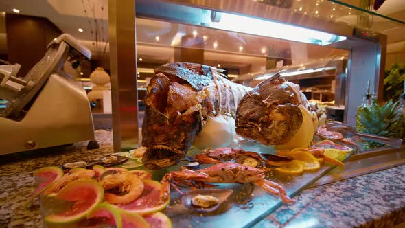 Tasty cooked fish laying on dish in self service restaurant.