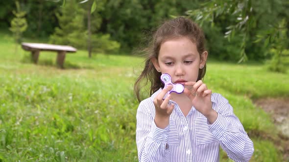 Hand Spinner Rotating on Child's Hand Slow Motion